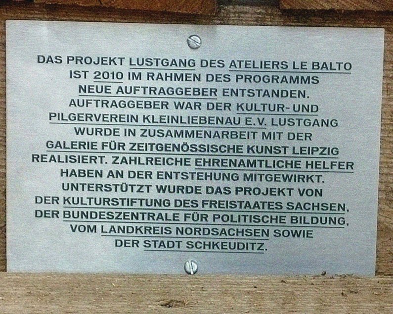 A descriptive panel explains the creation of the Pleasure Walk project within the framework of The New Patrons and by Atelier le balto in Kleinliebenau.
