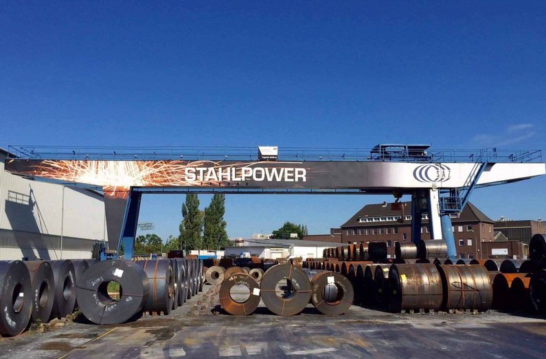 Industrial processing equipment with "Stahlpower" lettering on industrial premises
