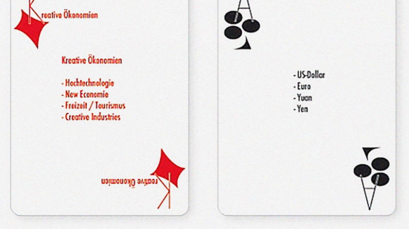 Two different playing cards with economic terms, King of Diamonds, Ace of Clubs